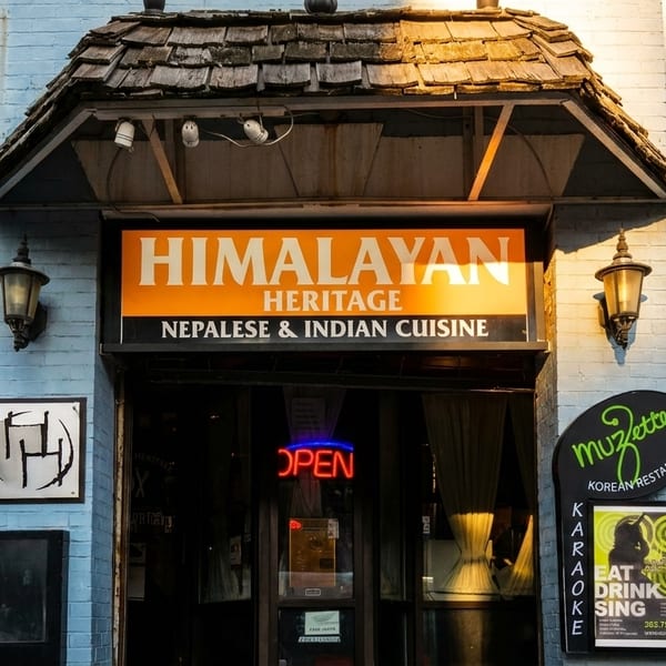 Exterior of Himalayan Heritage Nepalese & Indian Cuisine and Muzette Korean Restaurant with an "OPEN" sign.